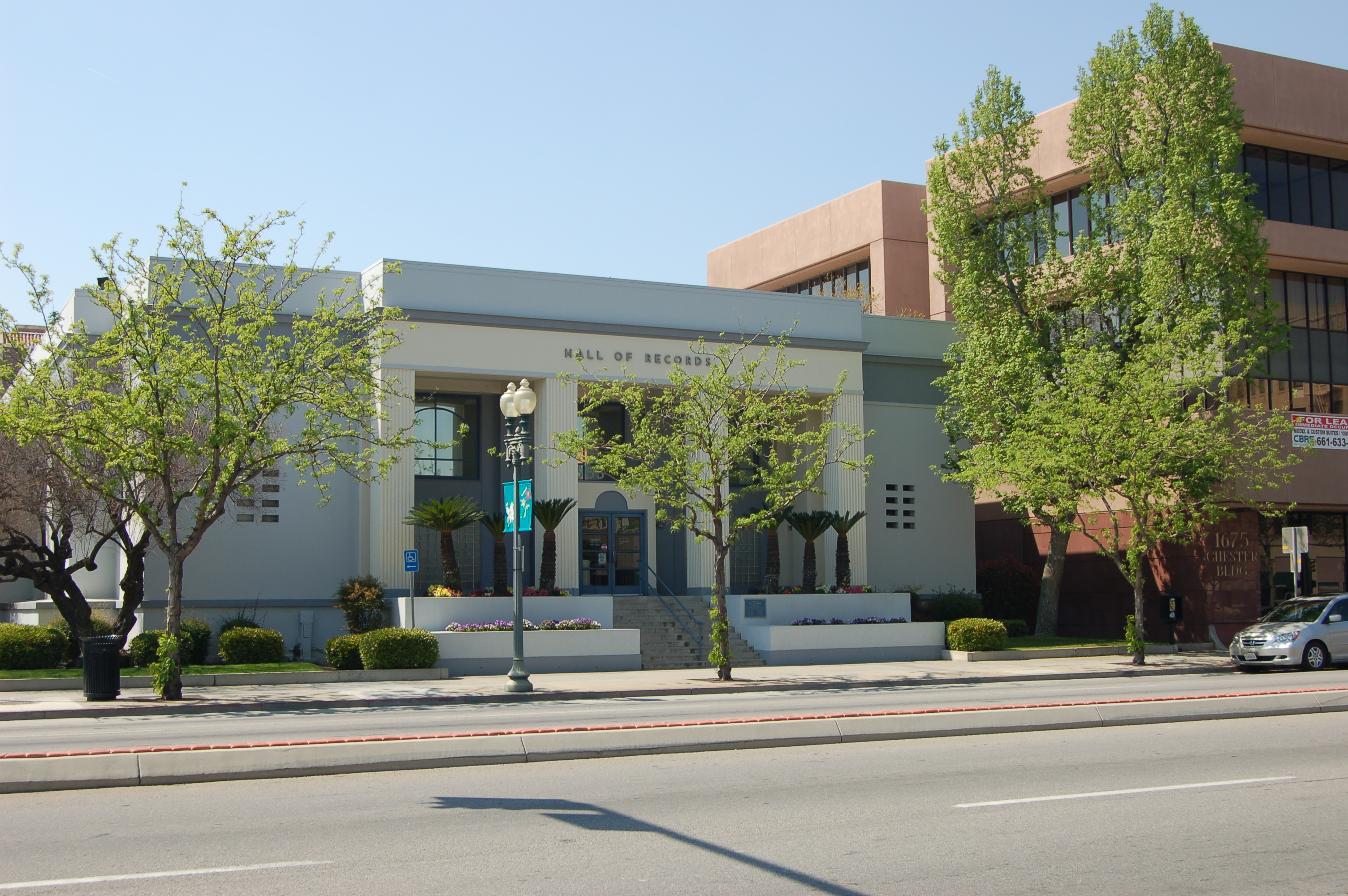The front of Kern County Hall of Records in downtown Bakersfield, with trees lining the sidewalk. Kern County Hall of Records in Bakersfield, pictured in 2011. Archival civic-building photograph.