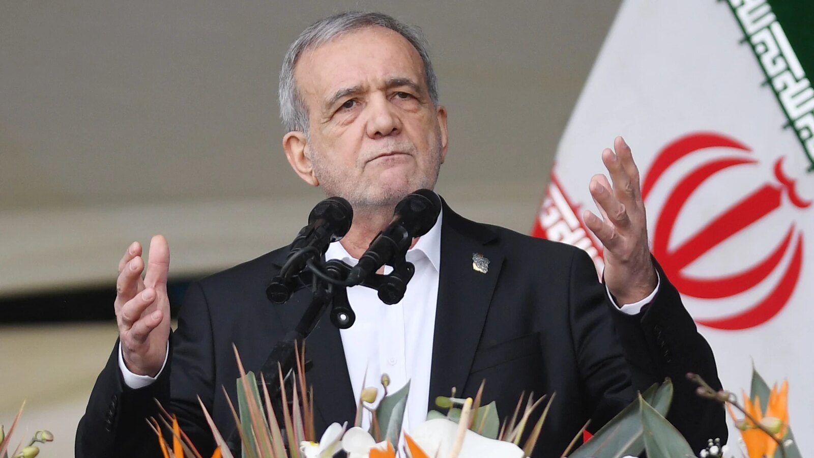 Iranian President Masoud Pezeshkian addresses the country from a podium in Tehran during the 2026 conflict