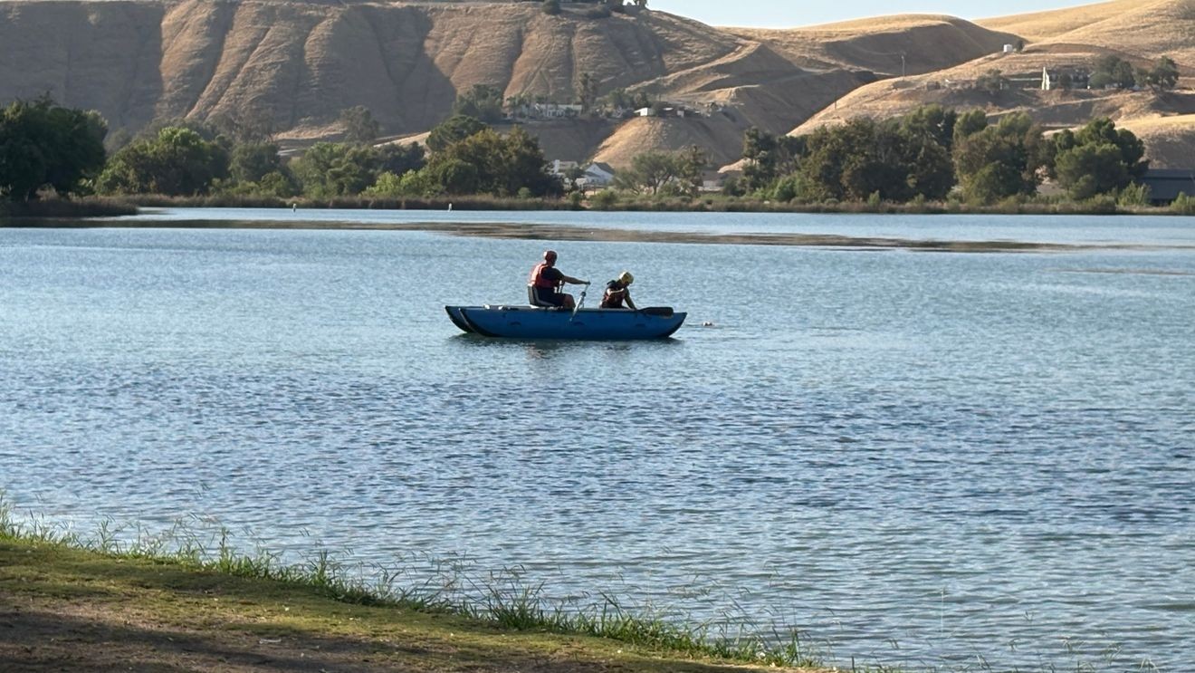 Search and rescue personnel in a small boat on Lake Ming during a body-recovery response on August 25, 2026