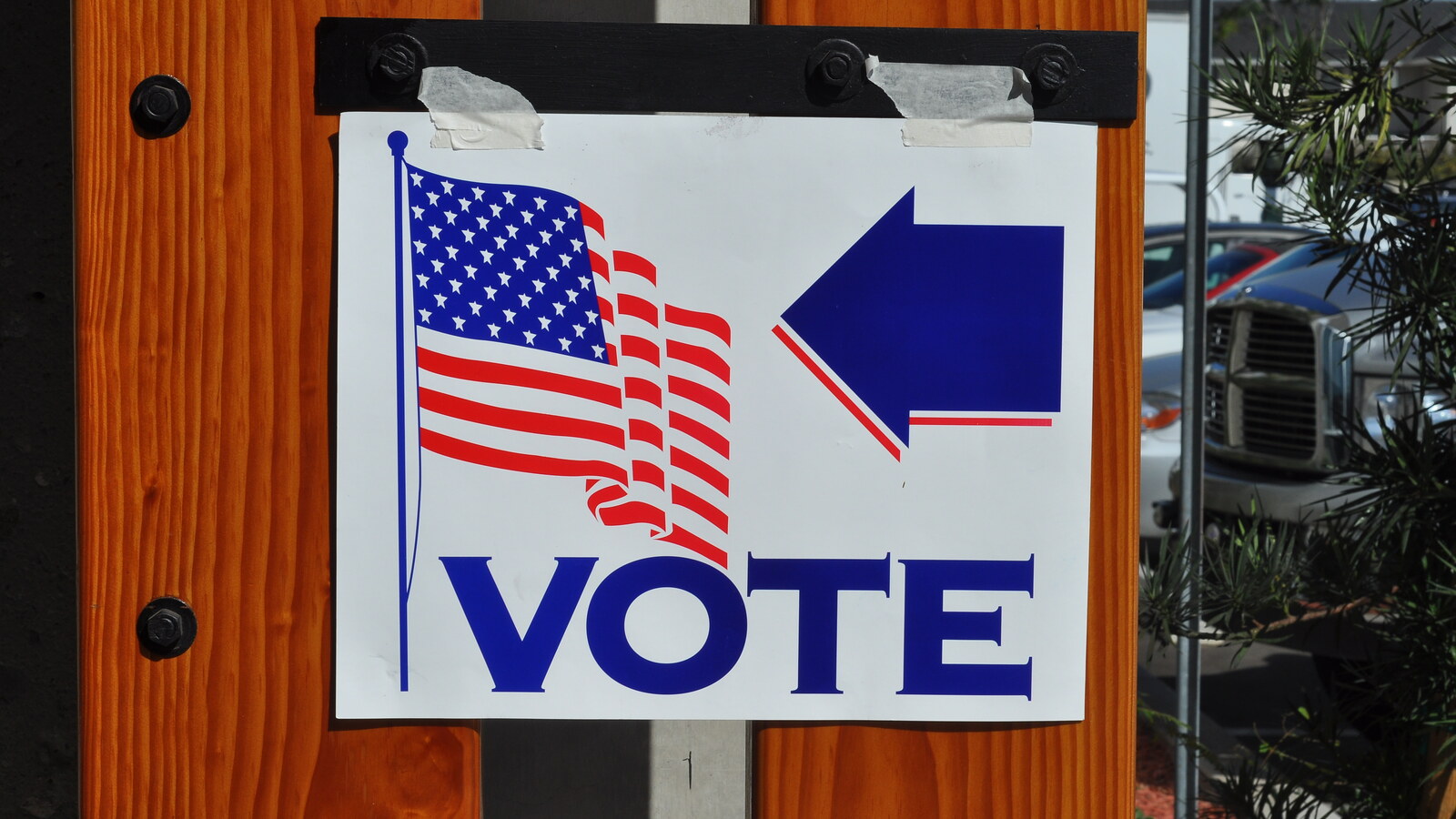 A 2008 file photograph of polling-place signs in Orange, California; it does not depict the federal lawsuit, database review or any person named in the report