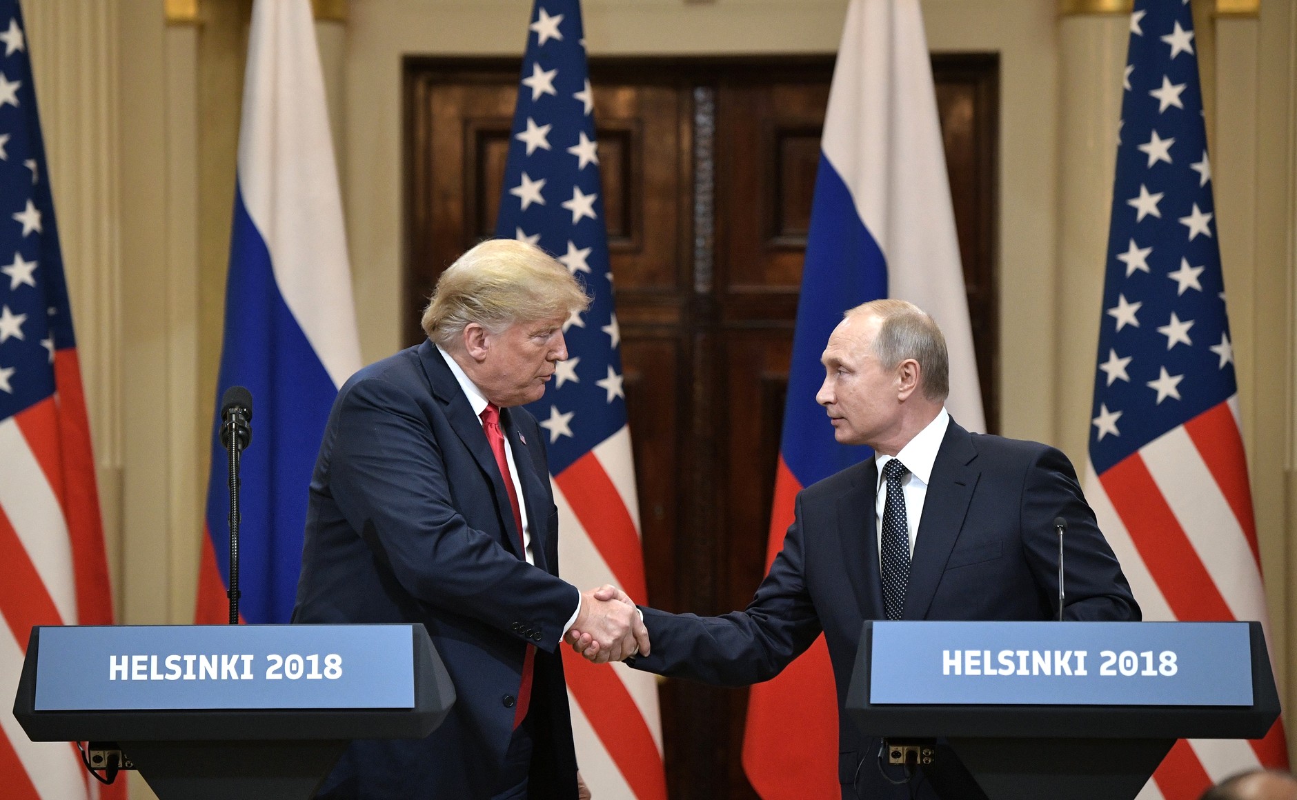 Donald Trump and Russian President Vladimir Putin shake hands after their joint press conference in Helsinki in July 2018