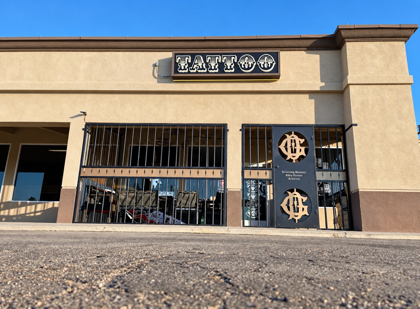 Exterior of the tattoo studio at 810 Norris Road in Bakersfield with a tattoo sign and security grilles