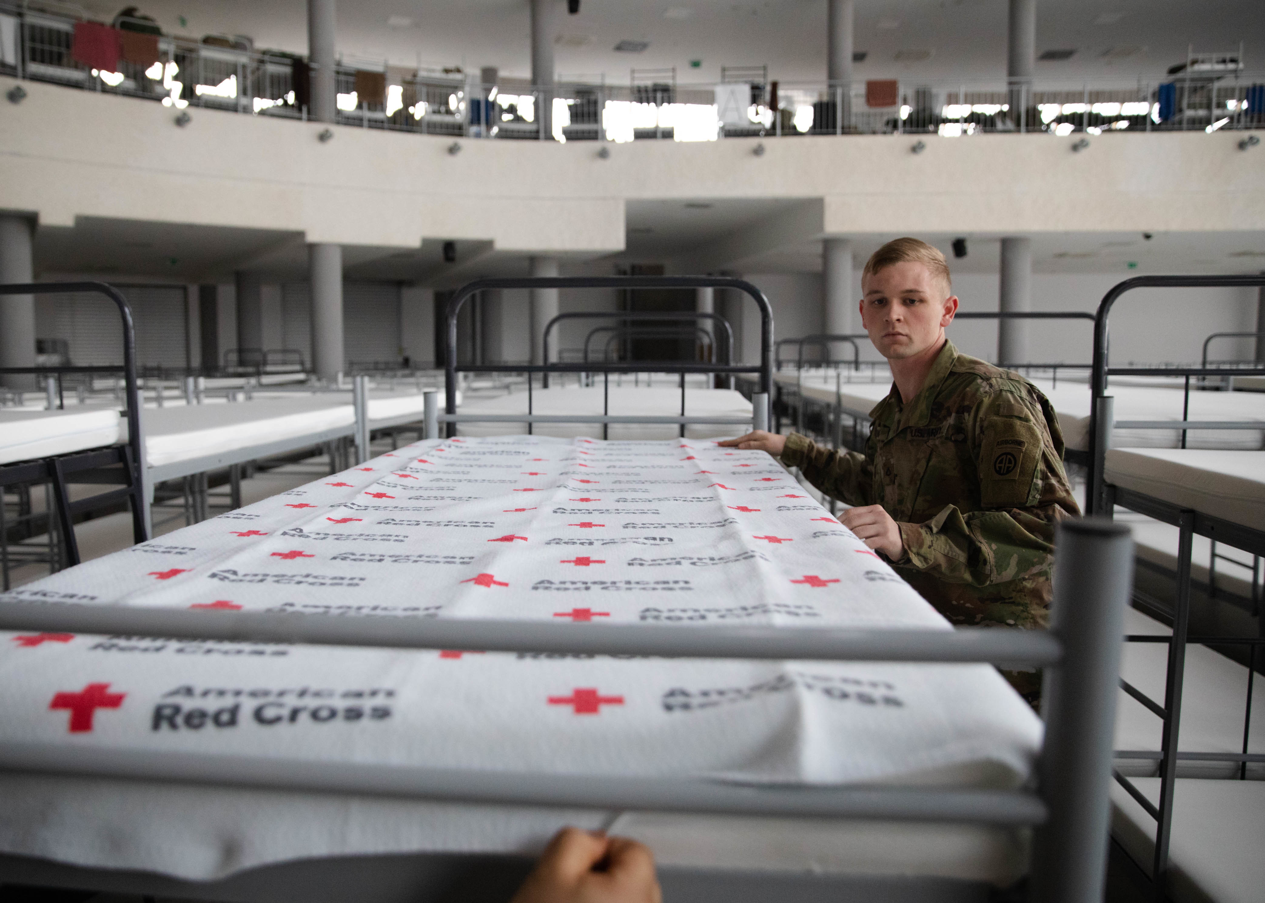 An 82nd Airborne Division soldier prepares shelter supplies in Jasionka, Poland, during a USAID-supported humanitarian operation in February 2022. Archival context, not a specific grant or termination examined in this report.