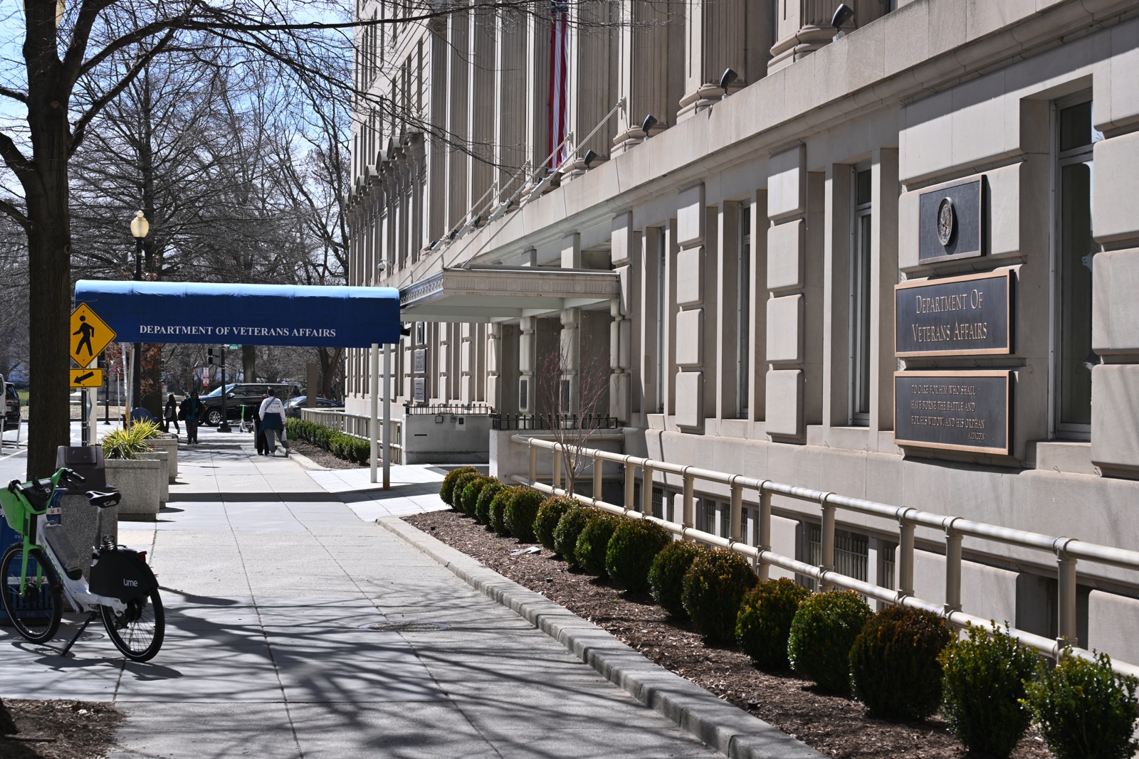 The sidewalk, blue entrance canopy and agency sign outside Department of Veterans Affairs headquarters in Washington, D.C., in March 2025.