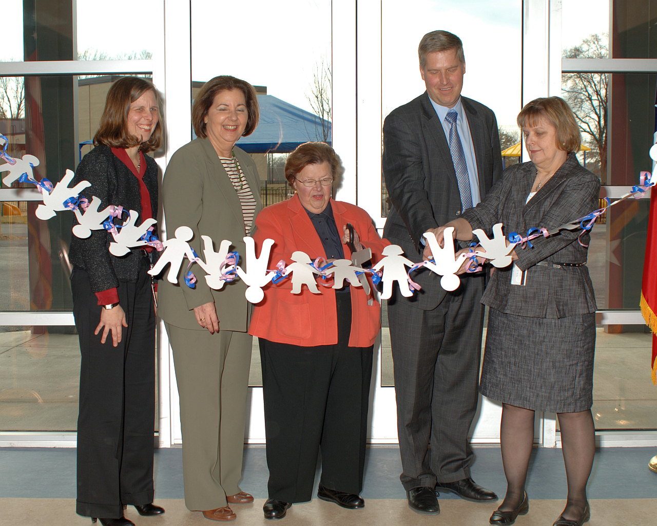 Officials cut a ribbon at a federal child-care center in Maryland.