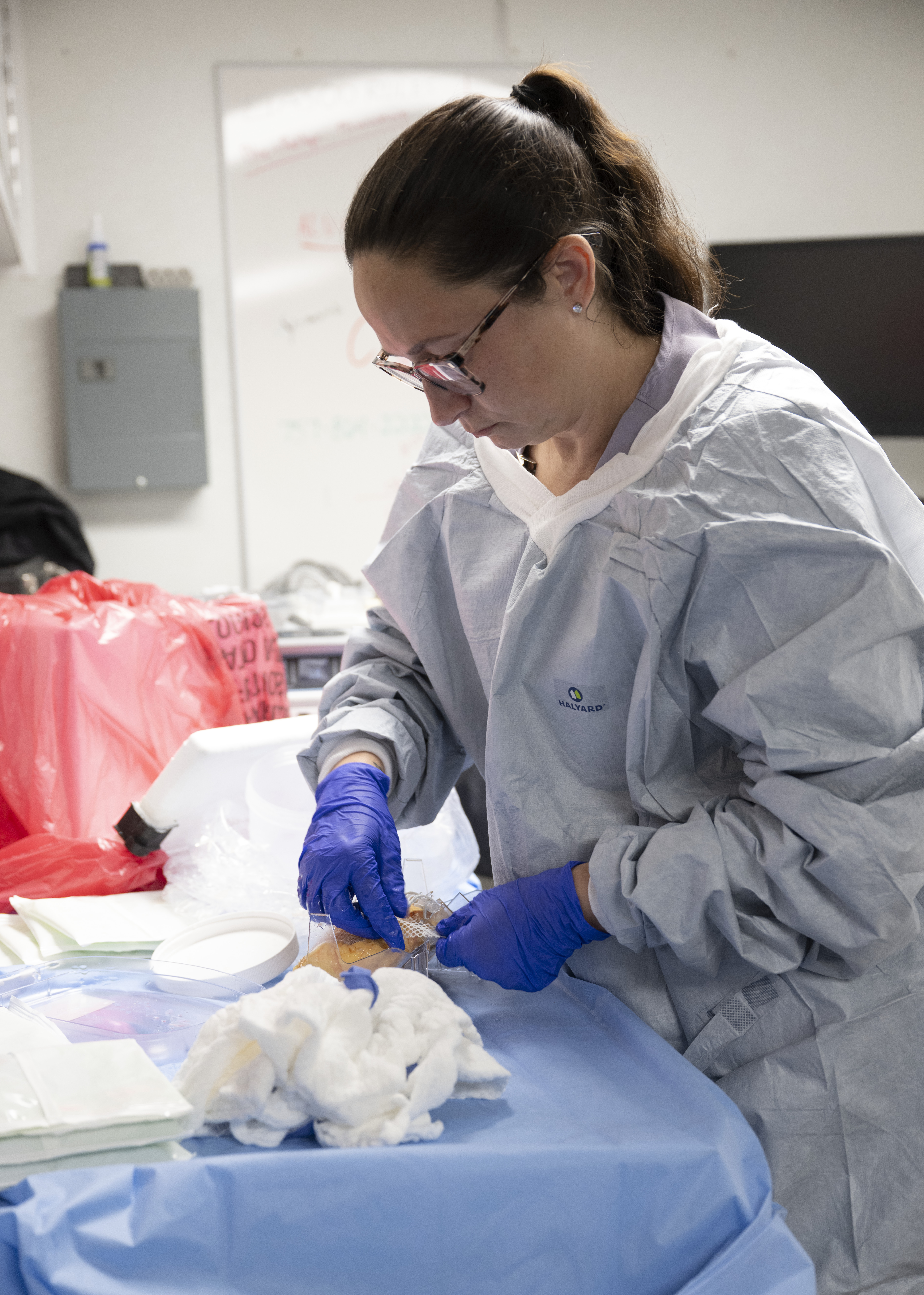 A worker handles a kidney during the NASA Langley and UNOS organ-transport drone test in Hampton, Virginia, June 5, 2026. The photograph does not show a shipment examined in the cost audit.