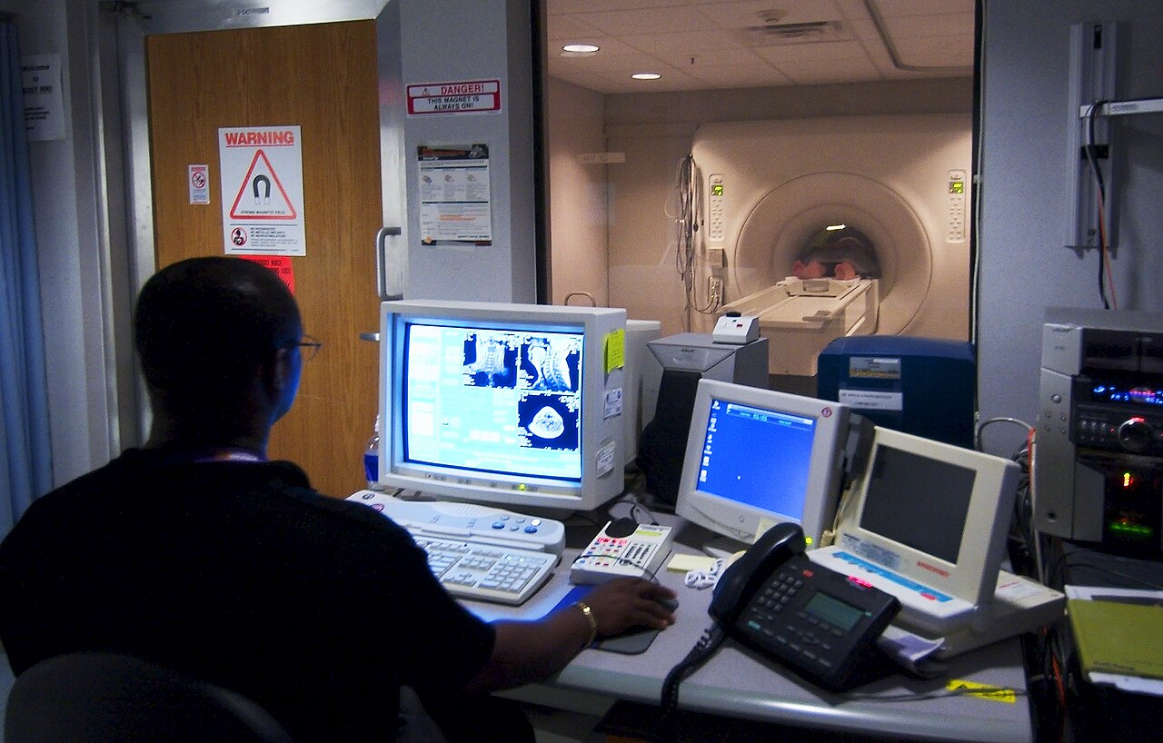 A technician monitors an MRI scanner at the National Naval Medical Center in Bethesda, Maryland, August 19, 2003. Archival medical-equipment context; not a VA facility, equipment inspection or maintenance failure examined by GAO. Photo: CWO4 Seth Rossman / U.S. Navy, public domain.