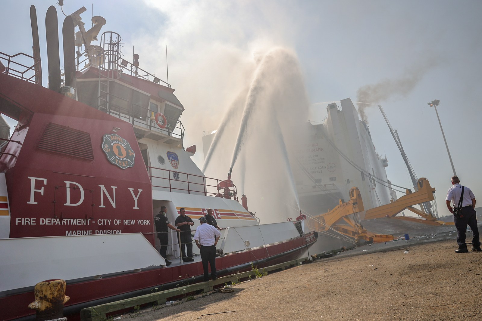 New York City Fire Department personnel and a fireboat respond to the Grande Costa D’Avorio vessel fire in Port Newark, New Jersey, July 6, 2023. Historical marine-firefighting response; the photograph does not establish any later change in Coast Guard preparedness. Photo: Dan Henry / U.S. Coast Guard, Public domain.