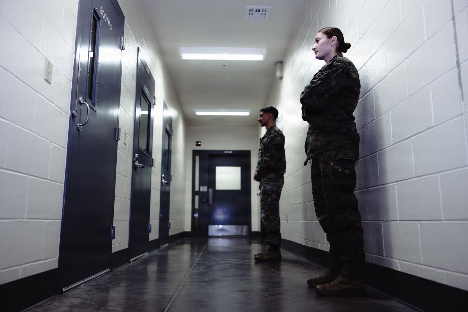 Marine correctional staff stand watch by legal-visit booths at Camp Lejeune Regional Brig, North Carolina, December 15, 2025. Occupational context only: not Kern County officers or a Kern County jail. Cpl. Loriann Dauscher/U.S. Marine Corps, public domain. The appearance of U.S. Department of War (DoW) visual information does not imply or constitute DoW endorsement.