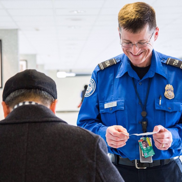 A TSA officer checks a passenger’s identification in a 2015 photograph.