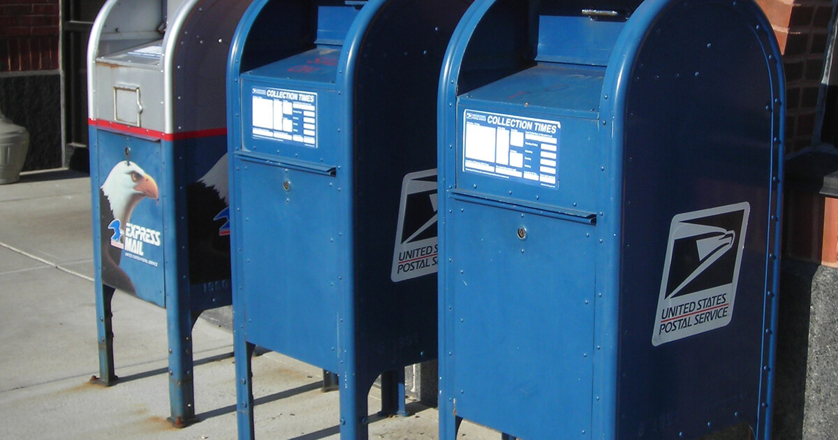 Authentic photograph of United States Postal Service collection boxes, used as context for the federal mail-ballot dispute