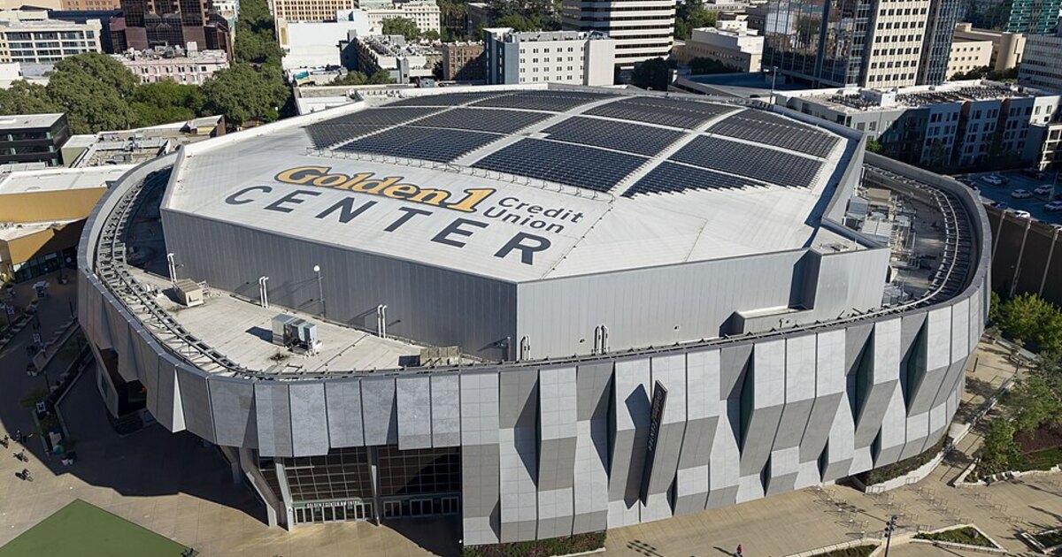 A real-world aerial view of a large sports arena used as context for event-based creator coverage